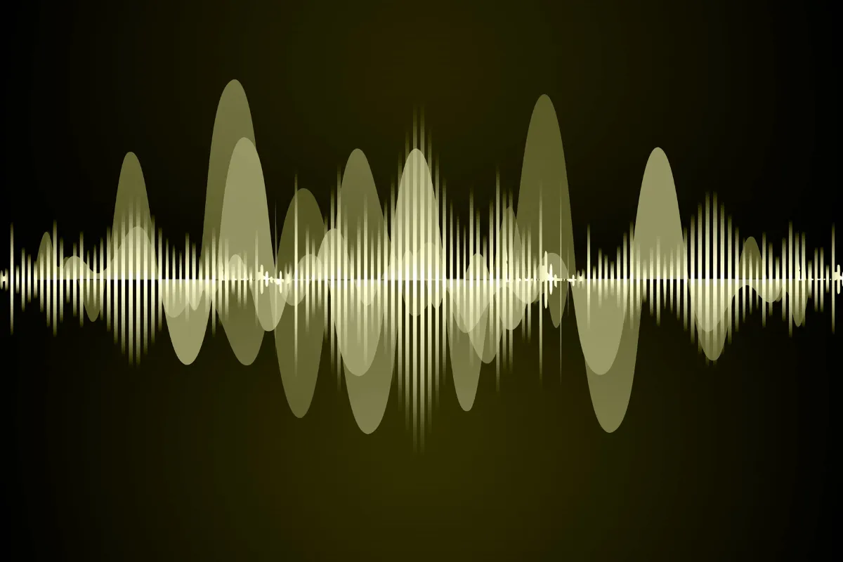 Gráfico de ondas sonoras em fundo escuro representando variações de frequência