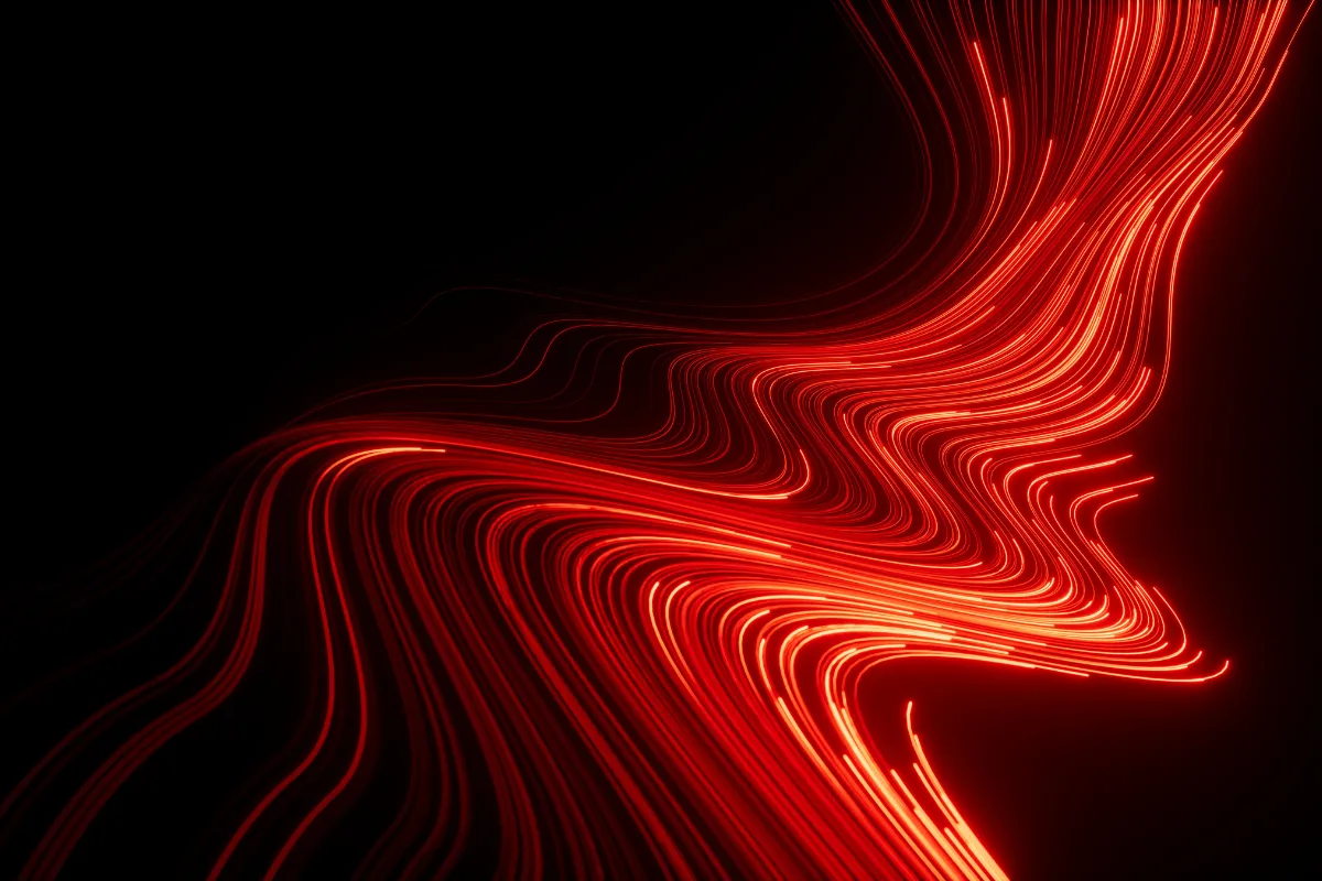 Linhas de luz vermelha formando curvas abstratas sobre um fundo escuro, criando um efeito visual de iluminação dinâmica.